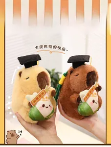 Close-up of Capybara plush pendants with graduation caps and lucky green pockets