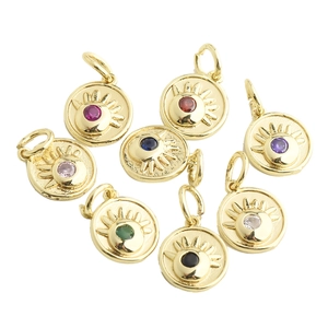 Close-up of golden evil eye pendants with colorful cubic zirconia for DIY jewelry making