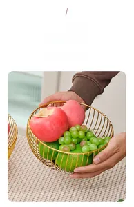 Detail of golden wire fruit basket with smooth edges showing interior texture and finish