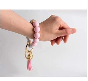 Detail of pink silicone beads and marble pattern bead keychain with a leather tassel