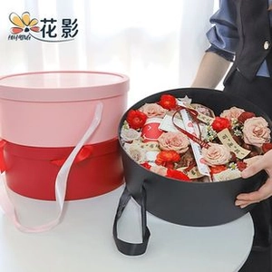 Three-color round flower gift boxes with satin handles and pink rose arrangement