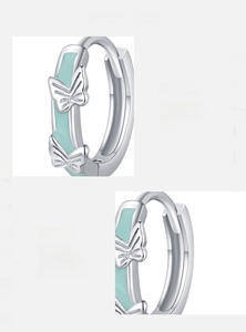 Macro detail of S925 sterling silver hoop earrings with mint green butterfly enamel craft