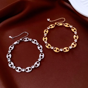 Close-up of gold and silver pig nose link bracelets with cubic zirconia and lobster clasp