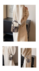 Detailed views of a mini silver cylindrical box bag with a top handle and chain strap
