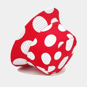 Reversible bucket hat with red mushroom polka dot pattern for sun protection outdoors