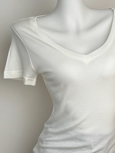 Detailed close-up of white V-neck wool blend t-shirt neckline and short sleeve texture