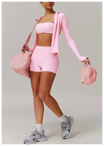 Three-piece pink yoga set with zip-up jacket, sports bra, and high-waist shorts for fitness