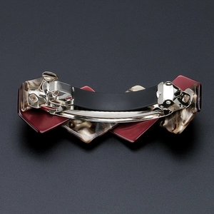 Elegant tortoiseshell acetate hair clip with deep red and marble geometric pattern design
