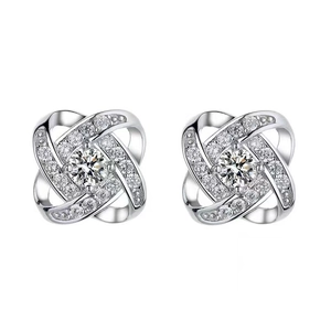 Close-up of sparkling silver stud earrings with exquisite floral zircon inlay details