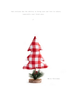 Close-up of red and white plaid fabric mini Christmas tree with a natural wooden base
