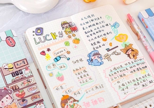 Close-up of cute cartoon planner stickers on a grid journal with pastel color palette