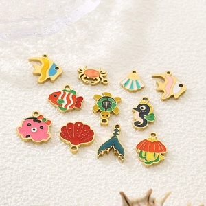 Macro shot of 11 colorful enamel ocean animal charms including turtles, crabs and seahorses