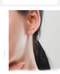 Close-up of elegant S925 silver hoop earrings featuring multiple micro pearls on model