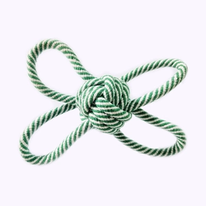 Close-up of green and white cotton rope pet toy with durable knotted weave structure