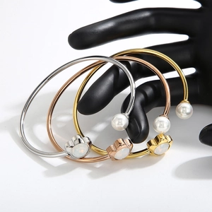 Three-color floral shell pearl open bangles in gold, rose gold and silver finishes