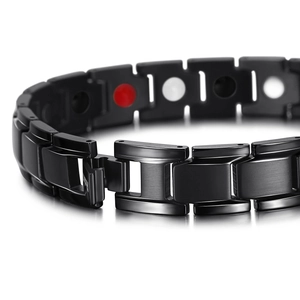 Detailed macro view of black titanium steel magnetic therapy link bracelet for men and women