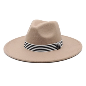 Macro detail of wide brim wool fedora with decorative striped band in khaki tone