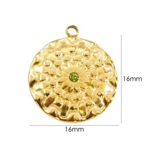 Close-up of 16mm 14K gold plated hammered flower pendant with green crystal stone