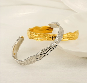 Detailed view of gold and silver irregular lava texture stainless steel bangles