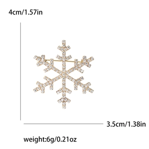 Golden snowflake brooch with white rhinestones and ruler measuring dimensions