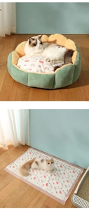 Detailed view of green flower-shaped pet bed with printed cushion on wooden floor