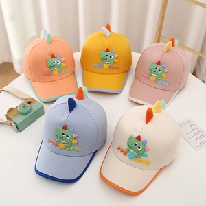 Detail of colorful children's baseball caps with cute cartoon dinosaur embroidery