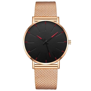 Minimalist ultra-thin watch with rose gold mesh band and black dial with red indices