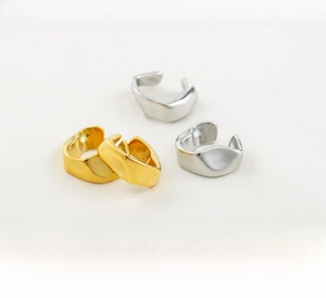 Detailed view of irregular geometric stainless steel ear cuffs in gold and silver finish