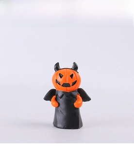 Detail of Halloween pumpkin devil figurine with orange head and black cloak resin decor