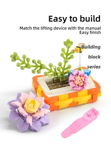 Detailed macro of building block flower pot with pink blossoms and cute little bee