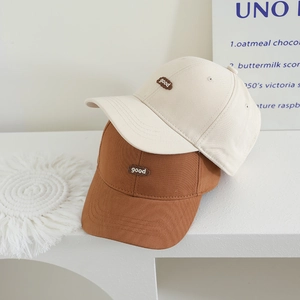 Beige and brown cotton baseball caps for kids featuring cloud-shaped 'good' embroidery