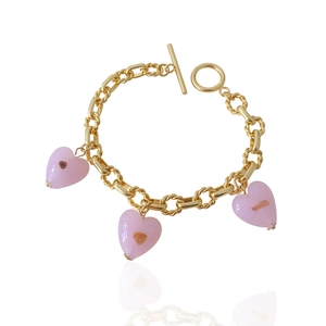 Detailed shot of golden link bracelet with pink heart glass pendants and OT toggle clasp