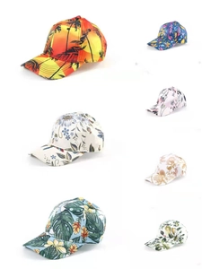Detail view of stylish baseball caps featuring tropical floral and sunset print patterns