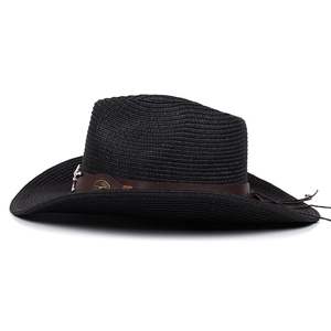 Close-up of black straw fedora with brown leather band and vintage metal bull head logo