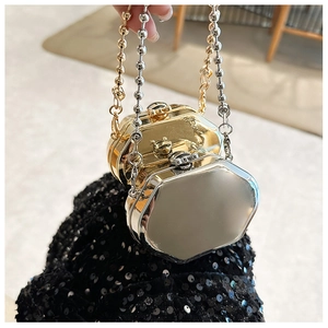Detail of mini gold and silver hexagonal metal bags with elegant beaded chain handles