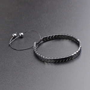 Close-up of hematite V-shaped bead bracelet with adjustable black braided string