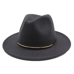 Detailed close-up of dark grey wool fedora hat with elegant black band and gold trim