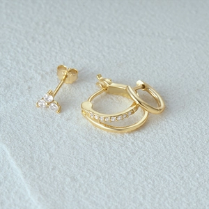 Detailed macro view of a 3-piece 925 silver gold earring set with tiny zircon studs