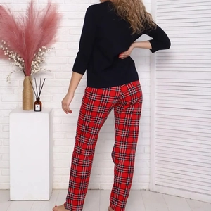 Women's pajama set featuring a slim black long-sleeve top and red plaid lounge pants
