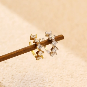 Macro shot of S925 silver ear cuffs with square zircon stones in gold and silver finish