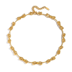 Detail of gold woven horseshoe chain necklace with toggle clasp and adjustable extension
