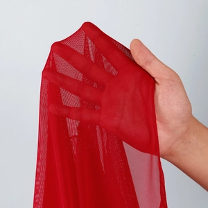 Detail showing the sheer texture and red mesh fabric of this four-piece bikini swimsuit