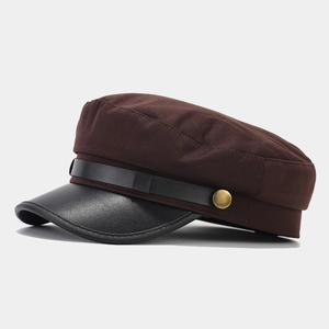 Detail of vintage navy cap showing dark brown twill fabric and black leather visor