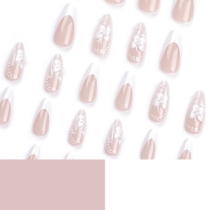 French white press-on nails with 3D bows, pearls and star accents on long almond shape