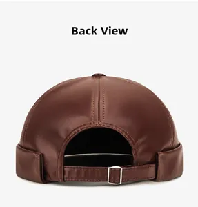 Detail view of brown PU leather skull cap featuring adjustable strap and metal buckle