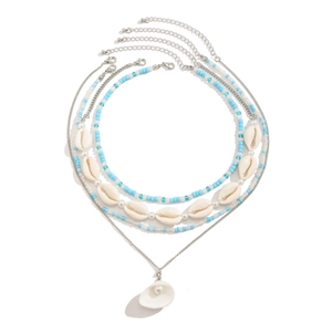 Detail of layered bohemian necklace with sun flower shell pendant and summer beads