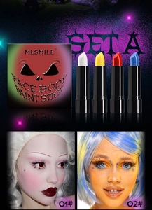 Macro view of four Halloween face body paint sticks in white, yellow, red, and blue colors