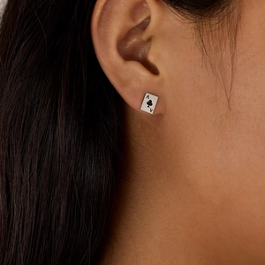 Close-up of Ace of Spades poker earrings in silver titanium steel on a model