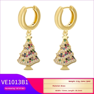 Detail view of gold brass Christmas tree earrings featuring multi-color zircon inlay