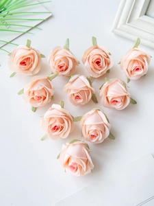 Detailed top view of pink silk rose flower heads arranged in a romantic heart shape